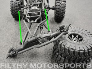 A photo of a vehicle chassis at full articulation with arrows between the shock mounts