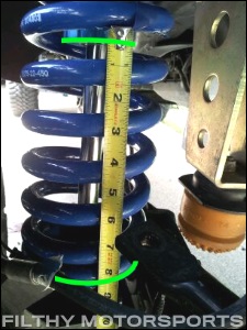 A photo of a tape measure measuring the shock shaft exposed on an installed coilvoer