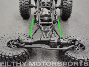 A photo of a vehicle chassis at ride height with arrows between the shock mounts