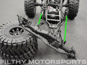 A photo of a vehicle chassis at full articulation the other way with arrows between the shock mounts