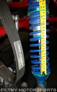 A photo of the lower spring on a coilover with a tape measure next to it